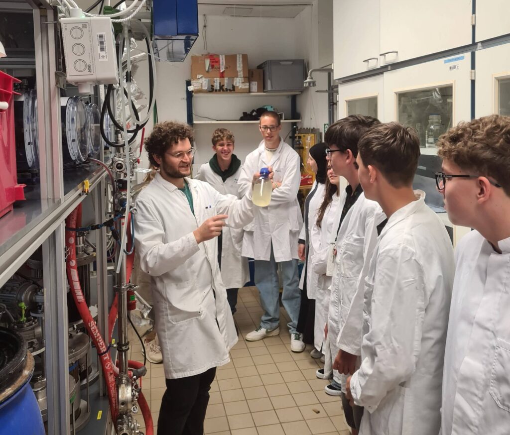 High school students viewing an experiment. 